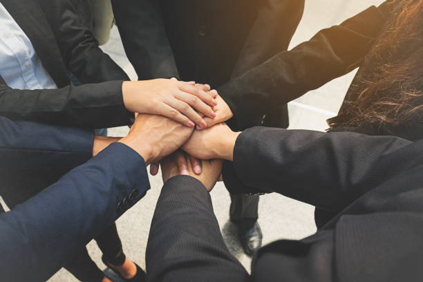 istock Group of business people joining hands. Team work concept. 825244178