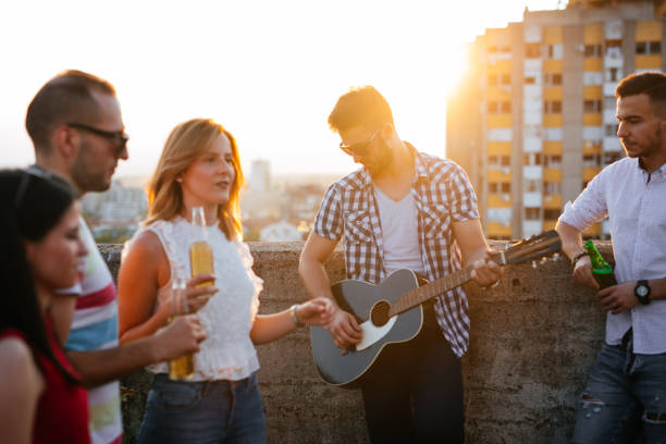 istock Friends have fun in rooftop party 825244434