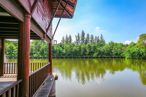 istock Partial of Old style  thai house on the river with blue sky 825250506