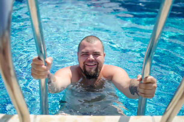 istock Man in the the swimming pool. 825251036