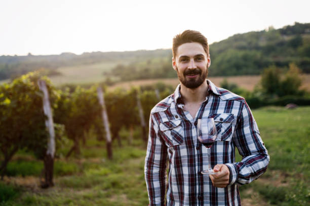 istock Winegrower tasting wine in vineyard 825251608