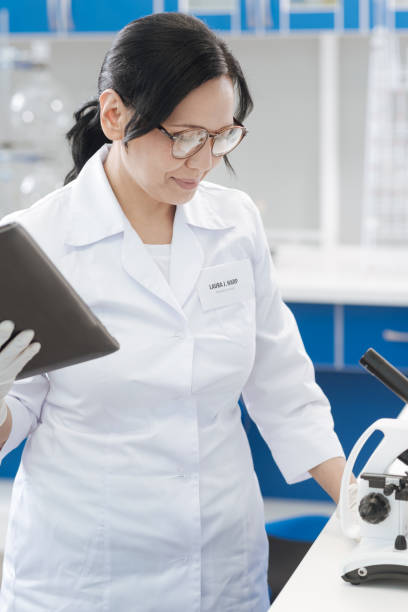 istock Smart positive biologist checking the equipment 825258476