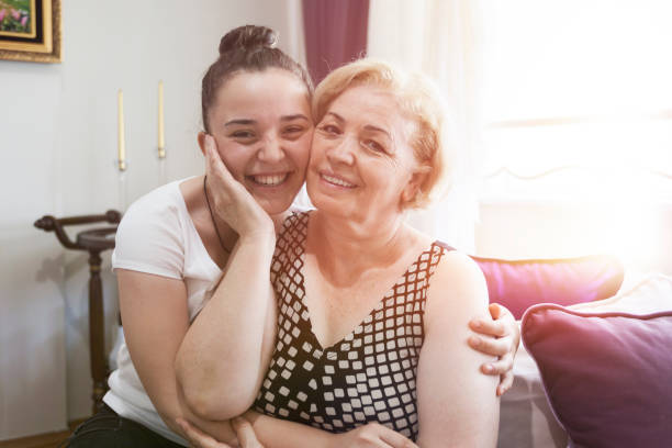 istock Smiling mother and young daughter posing to camera 825258724