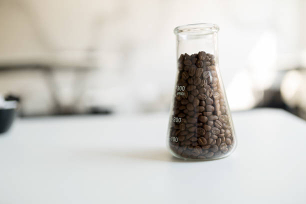 istock Dark roasted coffee beans on table in restaurant in glass 825267058