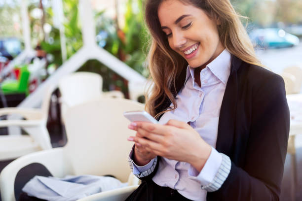istock Beautiful woman using cellphone to text 825267280