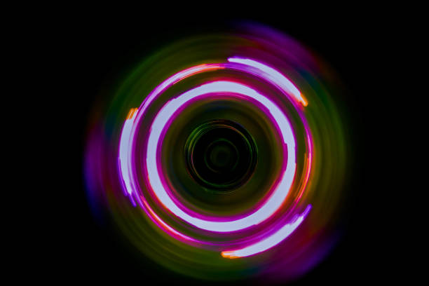 istock Colorful light neon circle in dark black background 825272460