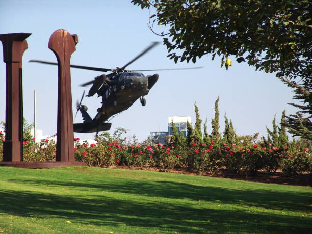 istock Military Helicopter landing on the park lawn 825284352