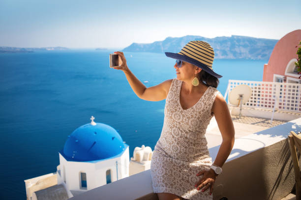 istock Woman taking a selfie in Santorini 825302122