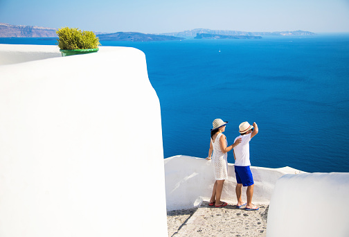 View of Oia in Santorini, the most famous village of the island with the typical white houses and blue domed churches