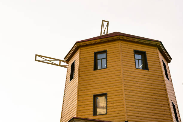 istock rustic old wooden windmill against the sky 825320134