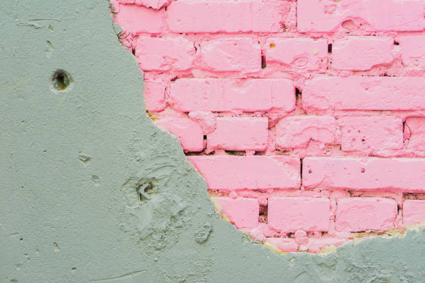 istock Abstract beautiful wall of grey cement and pink bricks. Rough damaged shabby texture with cracked. With place for text, for background 825321126