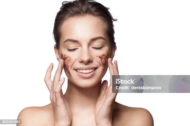 Closeup Portrait Of A Girl With A Brown Scrub On Her Face Doing Peeling Skin Isolated On White Background Stock Photo - Download Image Now