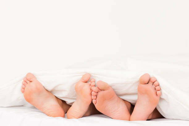 istock Two pair of feet next to each other 825332946