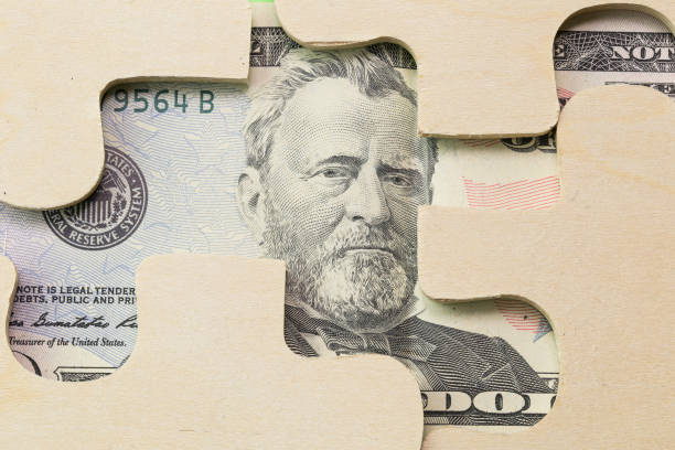 istock 50 usd dollar hidden under Puzzle, business concept of Solution 825333408