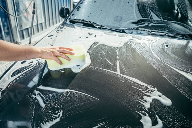 istock A Hand washing a car with a sponge 825342014