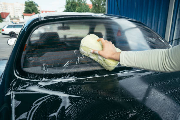 istock A Hand washing a car with a sponge 825344214
