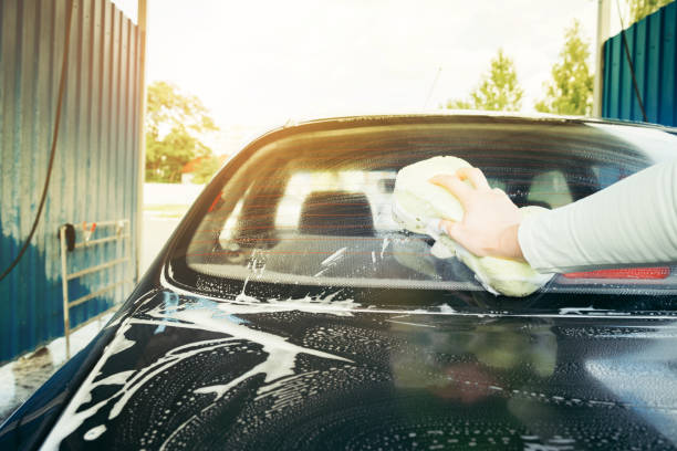 istock A Hand washing a car with a sponge 825344268