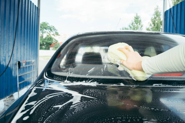 istock A Hand washing a car with a sponge 825344314