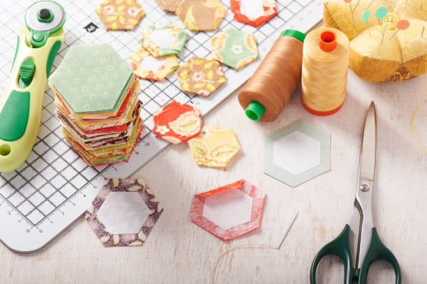 istock English paper pieced hexagons on white craft mat, sewing equipment 825348830