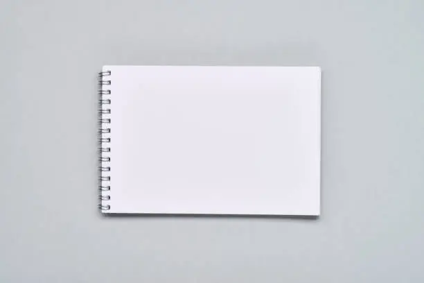 High angle view of spiral notepad with blank white page