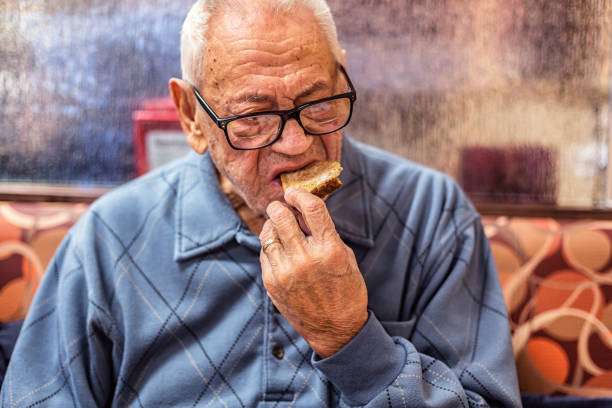 istock Elderly Senior Adult Man Breakfast Diner Biting Toasted Bread 825356272