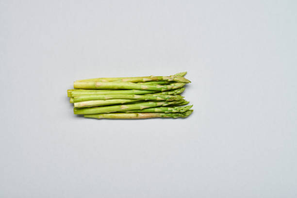 Directly above view of crop of fresh green young asparagus used for cooking healthy food