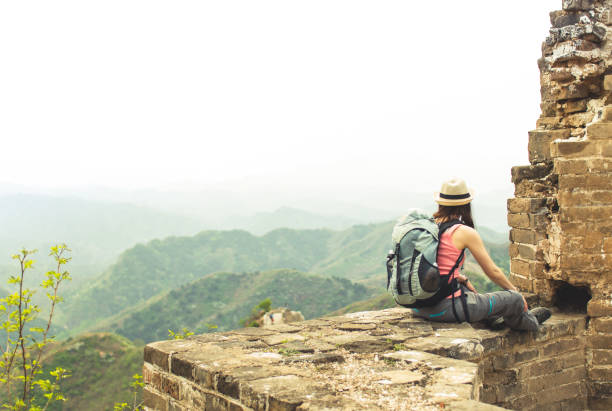 istock Female sitting on great wall by Jinshaling 825360030