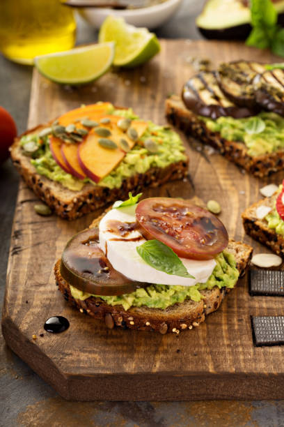 istock Variety of avocado toasts on a cutting board 825364038
