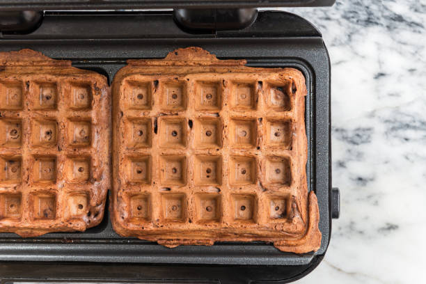 istock Belgium Waffles freshly made at home in the Waffle Maker 825367322