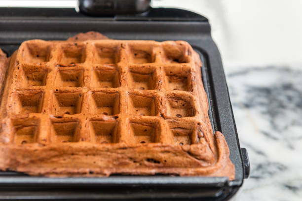 istock Belgium Waffles freshly made at home in the Waffle Maker 825367574