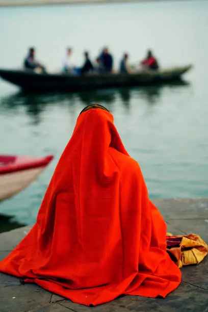 Holy Indian Sadhu wearing an orange turban with a red robe