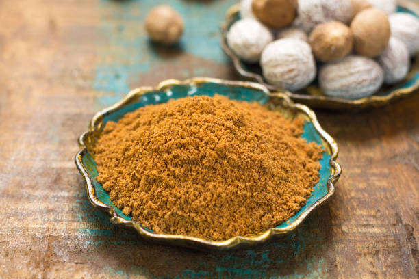 istock Nutmeg powder. Macro view whole nuts and grated muscat nuts. 825368150