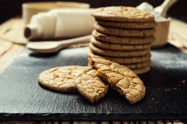 istock Biscuit sweet cookie background. Domestic stacked butter biscuit pattern concept,close up macro.Homemade cookies on wooden table.Cereal biscuits with the sesame,peanuts,sunflower and amaranth. 825371614