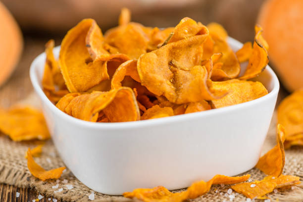 istock Sweet Potato Chips on wooden background; selective focus 825371652