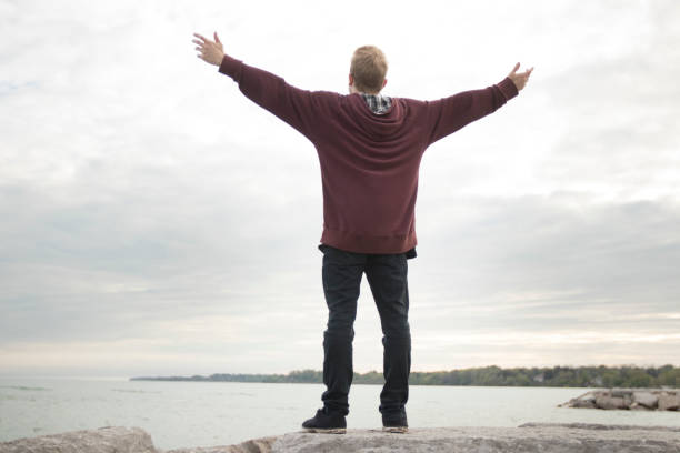 istock Young man with arms outstretched 825375300