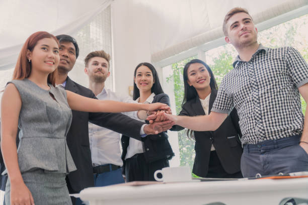 istock Group of Business people joining hands to work together. Teamwork Concept. 825382044
