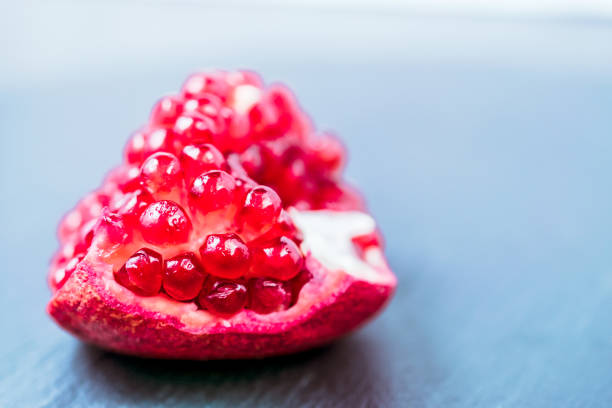 pomegranate fruit segment on dark vintage background  with copy space - usa restaurant flower bed beauty in nature imagens e fotografias de stock