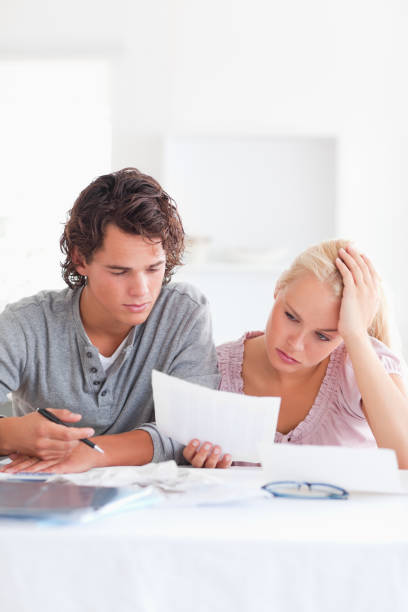 istock Worried Couple with Paperwork 825390056