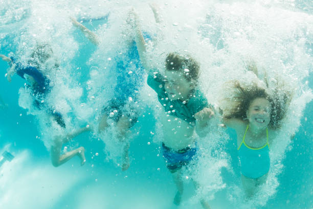 istock Group of children joyful underwater 825390776