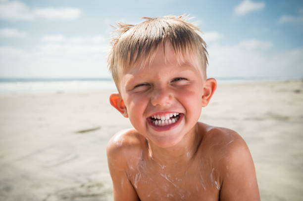 istock Blonde Boy Laughing At The Beach 825391642