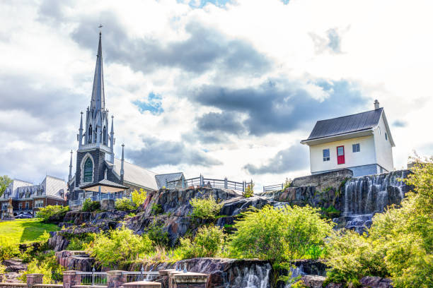 chicoutimi park in quebec mit fluss und wasser fließt im sommer und blick auf die kirche - chicoutimi travel locations nature city stock-fotos und bilder