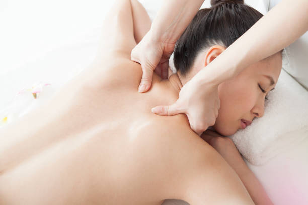 istock Young and beautiful women are massaged their backs by estheticians 825405568
