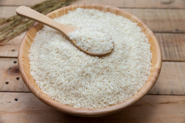istock raw rice in wooden bowl 825412952