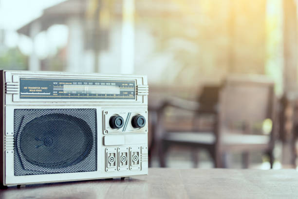 istock Retro radio cassette stereo on wooden table 825413534
