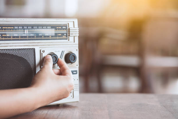 mano de mujer, ajuste el volumen del sonido en estéreo de cassette radio retro - wood texture audio fotografías e imágenes de stock