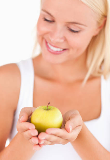 istock Gorgeous blond woman holding an apple 825415932