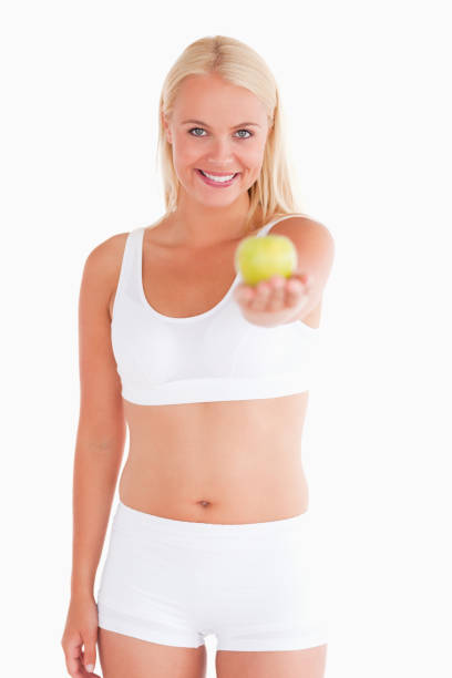 istock Cute woman holding an apple 825416176