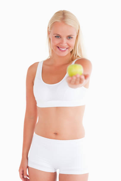 istock Gorgeous woman holding an apple 825416184