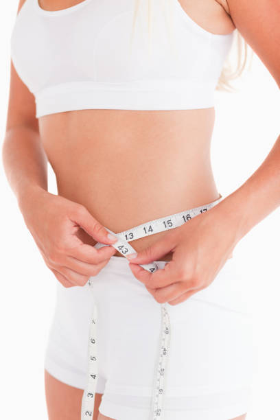 istock Fit woman measuring her waist 825416224