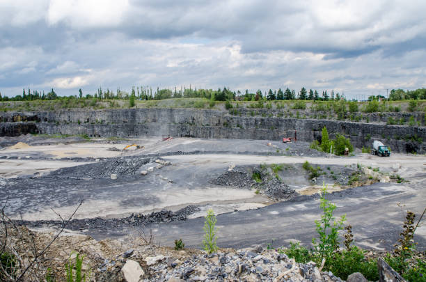 istock Industrial machinery at work in a stone-pit quarry during summer day 825416290